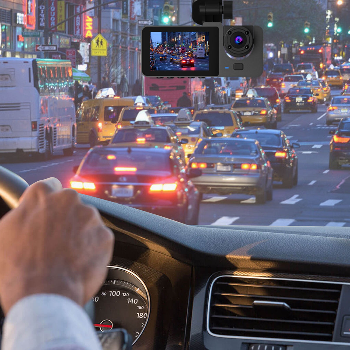 Dash cam mounted at the windshield in city traffic with the road ahead on its screen